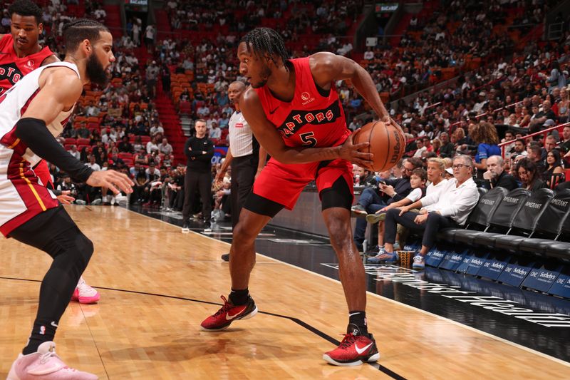 MIAMI, FL - APRIL 12:  Immanuel Quickley #5 of the Toronto Raptors handles the ball during the game against the Miami Heat on April 12, 2024 at Kaseya Center in Miami, Florida. NOTE TO USER: User expressly acknowledges and agrees that, by downloading and or using this Photograph, user is consenting to the terms and conditions of the Getty Images License Agreement. Mandatory Copyright Notice: Copyright 2024 NBAE (Photo by Issac Baldizon/NBAE via Getty Images)