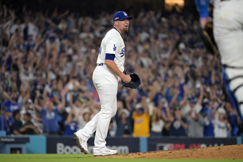 Oct 11, 2024; Los Angeles, California, USA; Los Angeles Dodgers pitcher Blake Treinen (49) celebrates after defeating the San Diego Padres during game five of the NLDS for the 2024 MLB Playoffs at Dodger Stadium. Mandatory Credit: Jayne Kamin-Oncea-Imagn Images