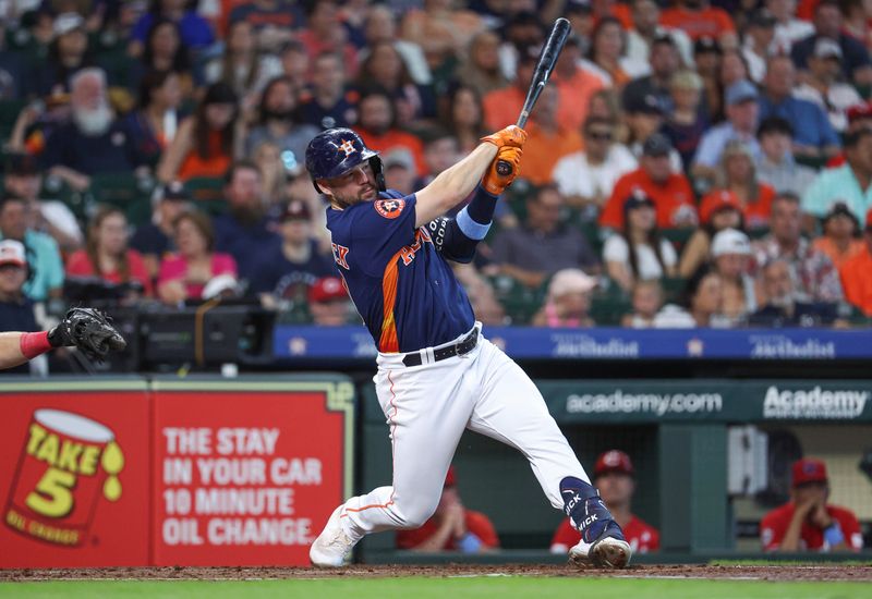 Jun 18, 2023; Houston, Texas, USA; Houston Astros center fielder Chas McCormick (20) hits an RBI single during the first inning against the Cincinnati Reds at Minute Maid Park. Mandatory Credit: Troy Taormina-USA TODAY Sports