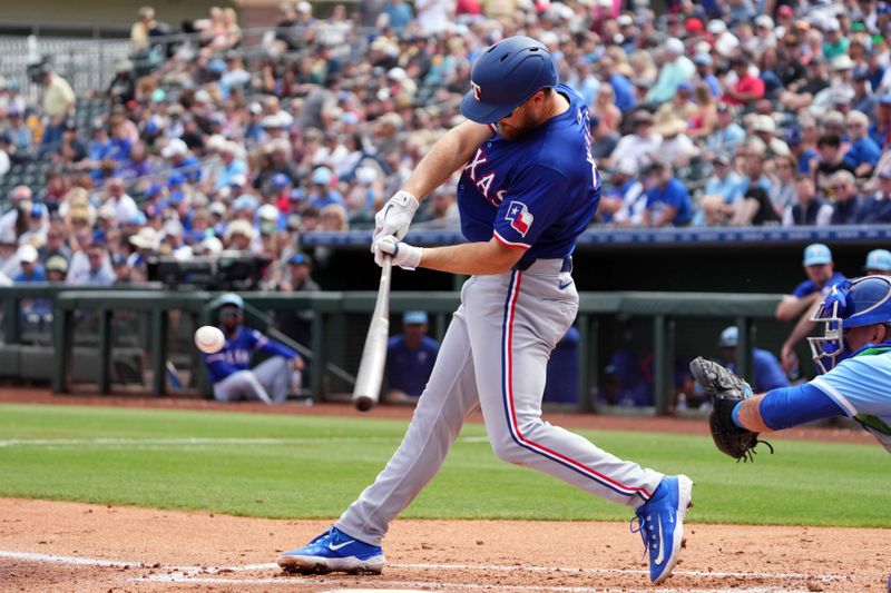 Mar 23, 2024; Surprise, Arizona, USA; Texas Rangers first baseman Jared Walsh (21) bats against the Kansas City Royals during the second inning at Surprise Stadium. Mandatory Credit: Joe Camporeale-USA TODAY Sports