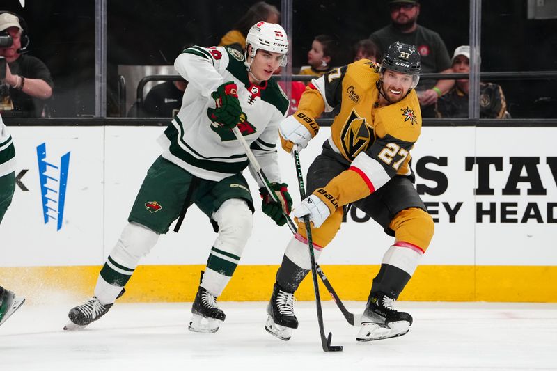 Apr 12, 2024; Las Vegas, Nevada, USA; Vegas Golden Knights defenseman Shea Theodore (27) steals the puck from Minnesota Wild left wing Liam Ohgren (28) during the second period at T-Mobile Arena. Mandatory Credit: Stephen R. Sylvanie-USA TODAY Sports