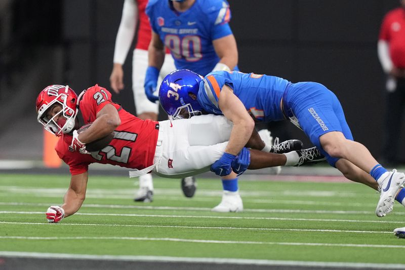 Dec 2, 2023; Las Vegas, NV, USA; Boise State Broncos safety Alexander Teubner (34) tackles UNLV Rebels wide receiver Jacob De Jesus (21) in the first half during the Mountain West Championship at Allegiant Stadium. Mandatory Credit: Kirby Lee-USA TODAY Sports