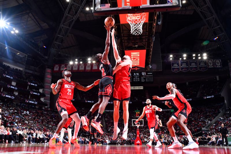 HOUSTON, TX - MARCH 21:   Ayo Dosunmu #12 of the Chicago Bulls and Jock Landale #2 of the Houston Rockets battle for a rebound on March 21, 2024 at the Toyota Center in Houston, Texas. NOTE TO USER: User expressly acknowledges and agrees that, by downloading and or using this photograph, User is consenting to the terms and conditions of the Getty Images License Agreement. Mandatory Copyright Notice: Copyright 2024 NBAE (Photo by Logan Riely/NBAE via Getty Images)