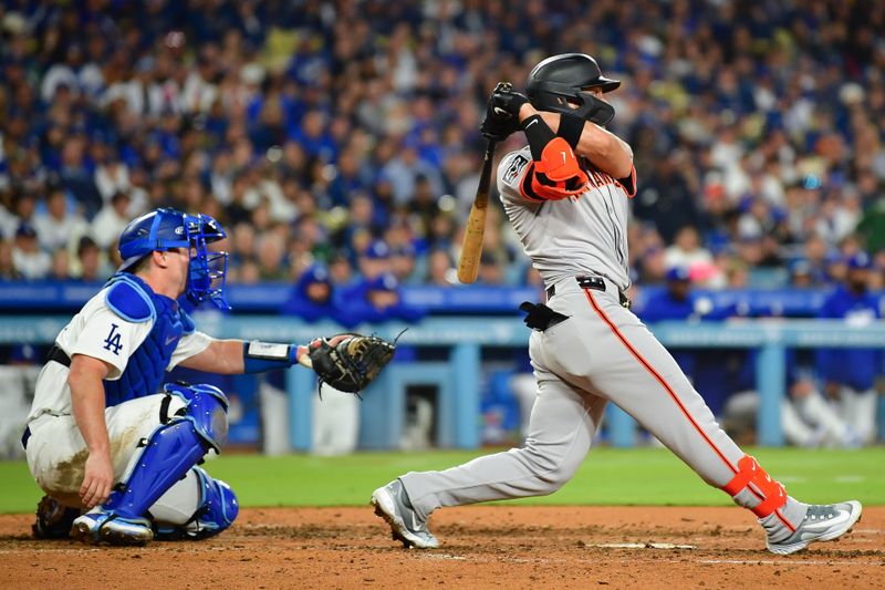 Apr 3, 2024; Los Angeles, California, USA; San Francisco Giants left fielder Michael Conforto (8) hits a two run RBI single against the Los Angeles Dodgers during the sixth inning at Dodger Stadium. Mandatory Credit: Gary A. Vasquez-USA TODAY Sports