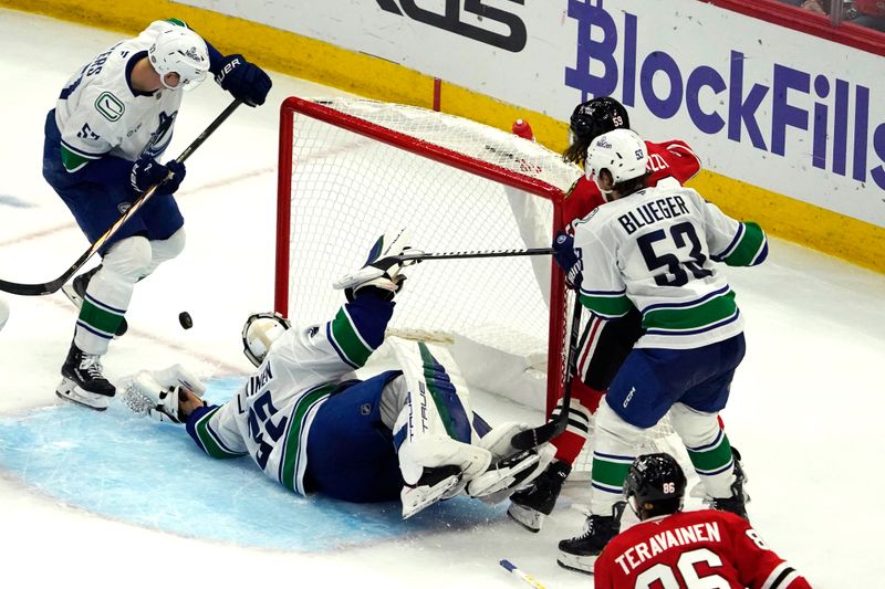 Oct 22, 2024; Chicago, Illinois, USA; Vancouver Canucks goaltender Kevin Lankinen (32) makes a save against the Chicago Blackhawks during the second period at United Center. Mandatory Credit: David Banks-Imagn Images