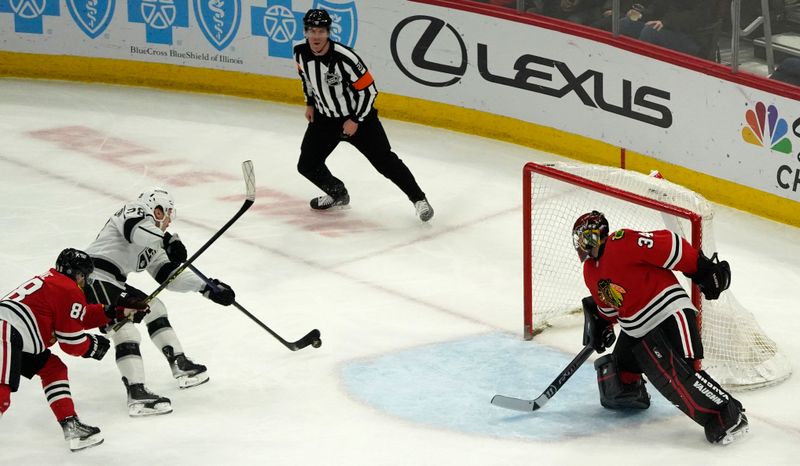 Jan 22, 2023; Chicago, Illinois, USA; Los Angeles Kings center Jaret Anderson-Dolan (28) shoots and scores a goal on Chicago Blackhawks goaltender Petr Mrazek (34) during the first period at United Center. Mandatory Credit: David Banks-USA TODAY Sports