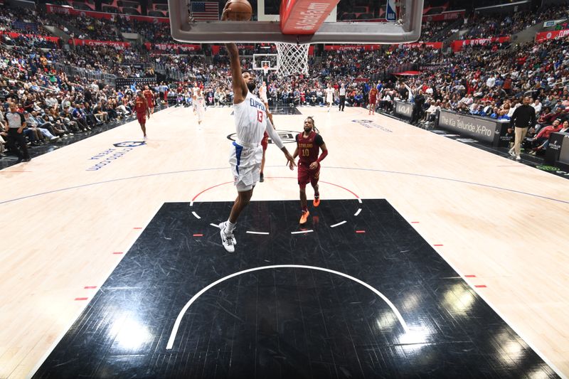 LOS ANGELES, CA - APRIL 7: Paul George #13 of the LA Clippers drives to the basket during the game against the Cleveland Cavaliers on April 7, 2024 at Crypto.Com Arena in Los Angeles, California. NOTE TO USER: User expressly acknowledges and agrees that, by downloading and/or using this Photograph, user is consenting to the terms and conditions of the Getty Images License Agreement. Mandatory Copyright Notice: Copyright 2024 NBAE (Photo by Adam Pantozzi/NBAE via Getty Images)