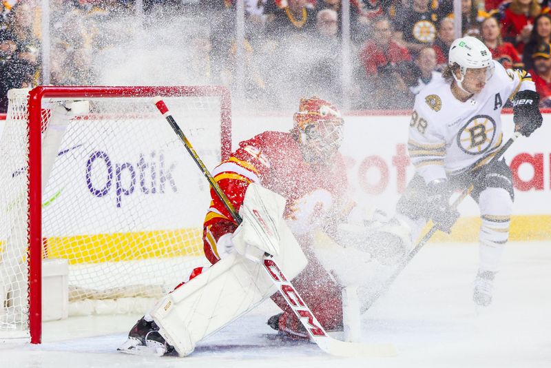 Feb 22, 2024; Calgary, Alberta, CAN; Calgary Flames goaltender Jacob Markstrom (25) guards his net against Boston Bruins right wing David Pastrnak (88) during the first period at Scotiabank Saddledome. Mandatory Credit: Sergei Belski-USA TODAY Sports