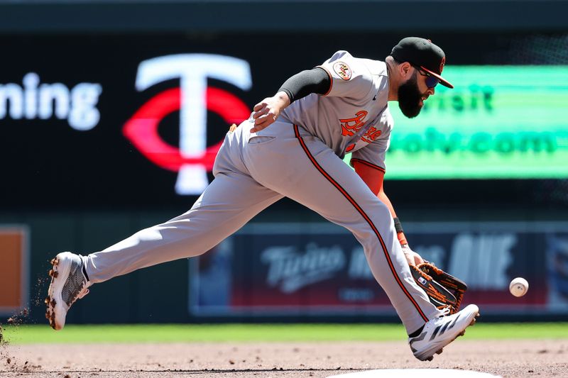 May 8, 2025; Minneapolis, Minnesota, USA; Baltimore Orioles third baseman Emmanuel Rivera (26) fields the ball hit by Minnesota Twins shortstop Carlos Correa (4) during the first inning against the Baltimore Orioles at Target Field. Mandatory Credit: Matt Krohn-Imagn Images