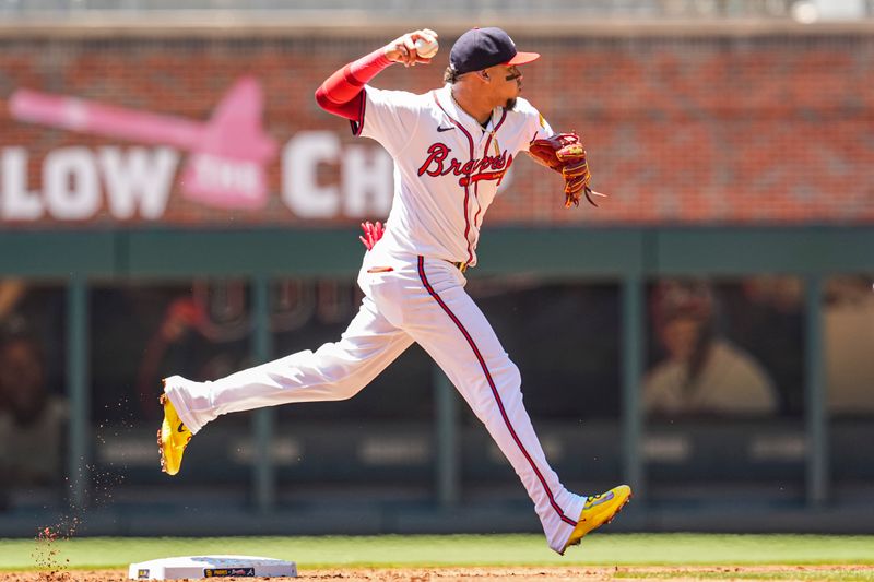 May 20, 2024; Cumberland, Georgia, USA; Atlanta Braves shortstop Orlando Arcia (11) throws for an out against the San Diego Padres during the third inning at Truist Park. Mandatory Credit: Dale Zanine-USA TODAY Sports