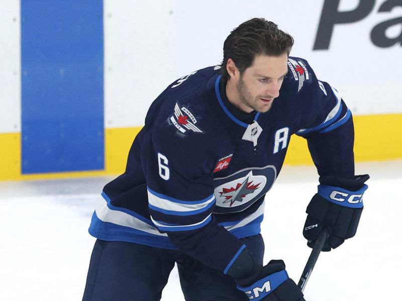 Sep 21, 2025; Winnipeg, Manitoba, CAN; Winnipeg Jets defenseman Colin Miller (6) warms up before a game against the Minnesota Wild at Canada Life Centre. Mandatory Credit: James Carey Lauder-Imagn Images