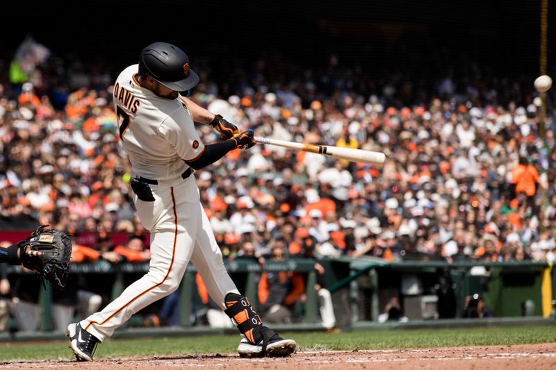 Apr 8, 2023; San Francisco, California, USA;  San Francisco Giants third baseman J.D. Davis (7) hits an RBI double against the Kansas City Royals during the fourth inning at Oracle Park. Mandatory Credit: John Hefti-USA TODAY Sports