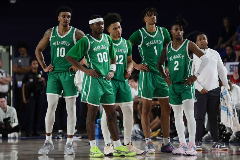 Jan 28, 2024; Boca Raton, Florida, USA; North Texas Mean Green forward Robert Allen (10), guard John Buggs III (00), guard CJ Noland (22), forward Aaron Scott (1), and guard Jason Edwards (2) look on from the court against the Florida Atlantic Owls during the second half at Eleanor R. Baldwin Arena. Mandatory Credit: Sam Navarro-USA TODAY Sports