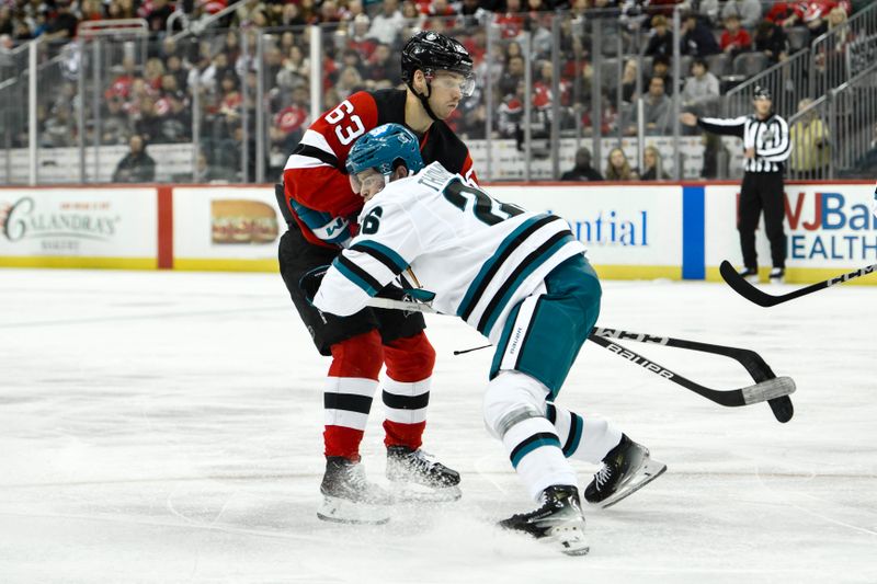 Nov 10, 2024; Newark, New Jersey, USA; New Jersey Devils left wing Jesper Bratt (63) tries to skate past San Jose Sharks defenseman Jack Thompson (26) during the second period at Prudential Center. Mandatory Credit: John Jones-Imagn Images