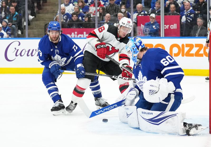 Mar 26, 2024; Toronto, Ontario, CAN; New Jersey Devils left wing Erik Haula (56) battles for the puck with Toronto Maple Leafs defenseman TJ Brodie (78) in front of  goaltender Joseph Woll (60) during the second period at Scotiabank Arena. Mandatory Credit: Nick Turchiaro-USA TODAY Sports