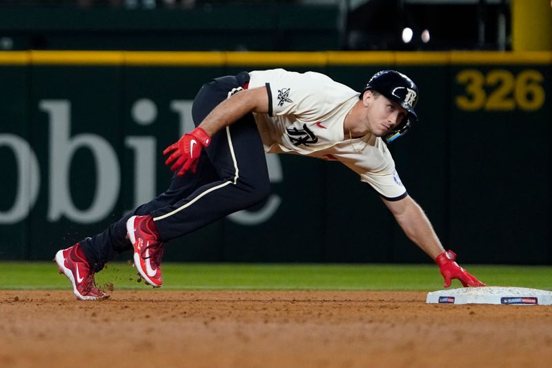 Aug 16, 2024; Arlington, Texas, USA; Texas Rangers outfielder Wyatt Langford (36) remains in contact with the base as he advances to second on an RBI single during the sixth inning against the Minnesota Twins at Globe Life Field. Mandatory Credit: Raymond Carlin III-USA TODAY Sports