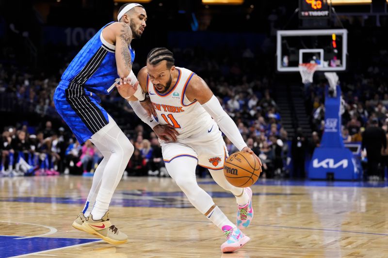 ORLANDO, FLORIDA - FEBRUARY 14: Jalen Brunson #11 of the New York Knicks dribbles the ball against Trevelin Queen #12 of the Orlando Magic during the first quarter at Kia Center on February 14, 2024 in Orlando, Florida. NOTE TO USER: User expressly acknowledges and agrees that, by downloading and or using this photograph, user is consenting to the terms and conditions of the Getty Images License Agreement. (Photo by Rich Storry/Getty Images)