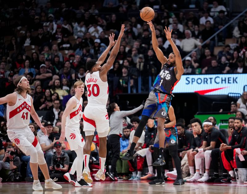 TORONTO, ON - MARCH 25: Mikal Bridges #1 of the Brooklyn Nets passes the ball against Ochai Agbaji #30 of the Toronto Raptors during the second half at the Scotiabank Arena on March 25, 2024 in Toronto, Ontario, Canada. NOTE TO USER: User expressly acknowledges and agrees that, by downloading and/or using this Photograph, user is consenting to the terms and conditions of the Getty Images License Agreement. (Photo by Mark Blinch/Getty Images)