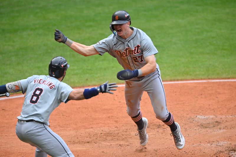 Oct 12, 2024; Cleveland, Ohio, USA; Detroit Tigers shortstop Trey Sweeney (27) celebrates a run with  outfielder Matt Vierling (8) in the fifth inning against the Cleveland Guardians during game five of the ALDS for the 2024 MLB Playoffs at Progressive Field. Mandatory Credit: David Richard-Imagn Images