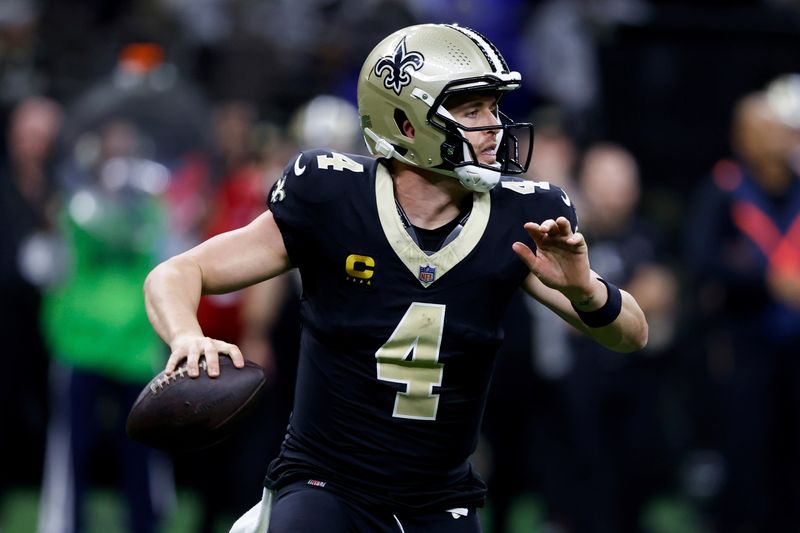 New Orleans Saints quarterback Derek Carr (4) prepares to throw a pass during the second half of an NFL football game against the Los Angeles Rams, Sunday, Dec. 1, 2024, in New Orleans. (AP Photo/Butch Dill)