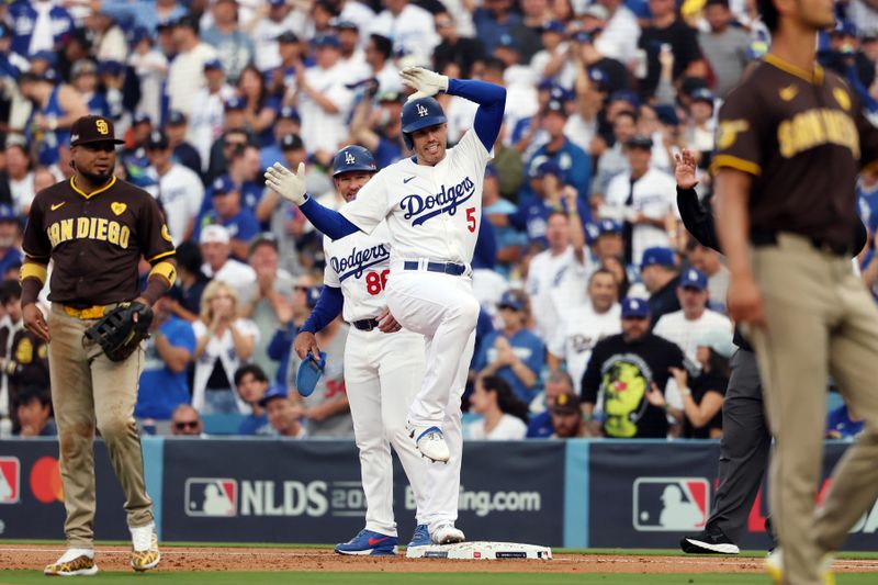 Oct 11, 2024; Los Angeles, California, USA; Los Angeles Dodgers first baseman Freddie Freeman (5) reacts at first base after hitting a single in the first inning against the San Diego Padres during game five of the NLDS for the 2024 MLB Playoffs at Dodger Stadium. Mandatory Credit: Kiyoshi Mio-Imagn Images
