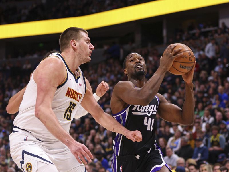 DENVER, COLORADO - FEBRUARY 28: Harrison Barnes #40 of the Sacramento Kings goes to the basket against Nikola Jokic #15 of the Denver Nuggets during the first quarter at Ball Arena on February 28, 2024 in Denver, Colorado. NOTE TO USER: User expressly acknowledges and agrees that, by downloading and or using this photograph, User is consenting to the terms and conditions of the Getty Images License Agreement. (Photo by Alysa Rubin/Clarkson Creative/Getty Images)