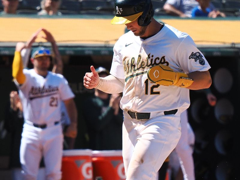 May 23, 2024; Oakland, California, USA; Oakland Athletics shortstop Max Shuemann (12) celebrates as he scores a run against the Colorado Rockies during the eleventh inning at Oakland-Alameda County Coliseum. Mandatory Credit: Kelley L Cox-USA TODAY Sports