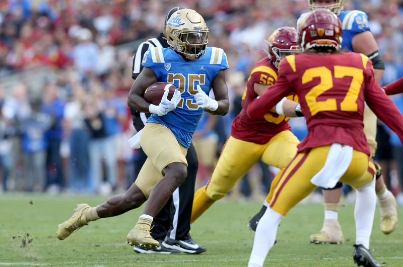 Nov 18, 2023; Los Angeles, California, USA; UCLA Bruins running back TJ Harden (25) runs during the first quarter against the USC Trojans at United Airlines Field at Los Angeles Memorial Coliseum. Mandatory Credit: Jason Parkhurst-USA TODAY Sports