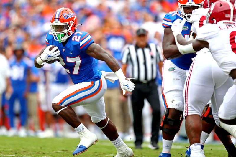 Sep 18, 2021; Gainesville, Florida, USA; Florida Gators running back Dameon Pierce (27) runs the ball during the first quarter against the Alabama Crimson Tide at Ben Hill Griffin Stadium. Mandatory Credit: Mark J. Rebilas-USA TODAY Sports