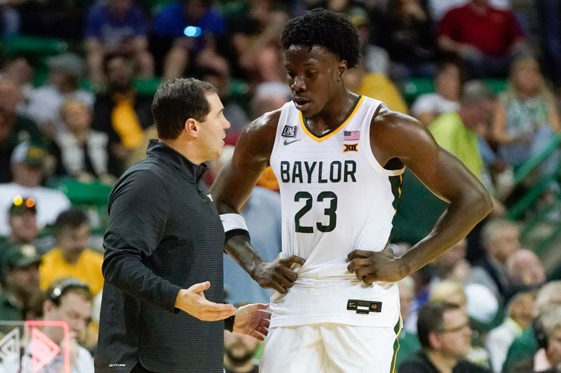 Mar 4, 2023; Waco, Texas, USA; Baylor Bears head coach Scott Drew talks with forward Jonathan Tchamwa Tchatchoua (23) during a time out against the Iowa State Cyclones in the second half at Ferrell Center. Mandatory Credit: Raymond Carlin III-USA TODAY Sports