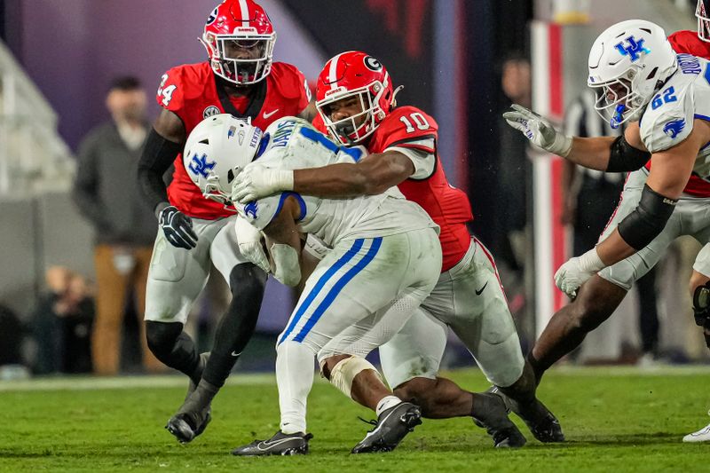 Oct 7, 2023; Athens, Georgia, USA; Georgia Bulldogs linebacker Jamon Dumas-Johnson (10) tackles Kentucky Wildcats running back Ray Davis (1) at Sanford Stadium. Mandatory Credit: Dale Zanine-USA TODAY Sports