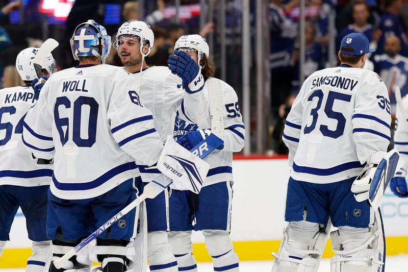 Oct 24, 2023; Washington, District of Columbia, USA; Toronto Maple Leafs goaltender Joseph Woll (60) celebrates with Maple Leafs center Auston Matthews (34) after their game against the Washington Capitals at Capital One Arena. Mandatory Credit: Geoff Burke-USA TODAY Sports