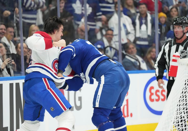 Oct 11, 2023; Toronto, Ontario, CAN; Toronto Maple Leafs right wing Ryan Reaves (75) fights with Montreal Canadiens defenseman Arber Xhekaj (72) during the first period at Scotiabank Arena. Mandatory Credit: Nick Turchiaro-USA TODAY Sports