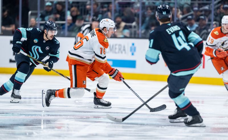 Jan 28, 2025; Seattle, Washington, USA;  Anaheim Ducks forward Ryan Strome (16) skates against Seattle Kraken forward Chandler Stephenson (9), left, and defenseman Ryker Evans (41) during the first period at Climate Pledge Arena. Mandatory Credit: Stephen Brashear-Imagn Images