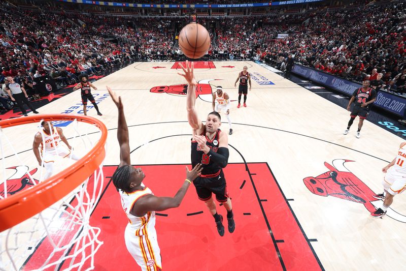 CHICAGO, IL - APRIL 17:  Nikola Vucevic #9 of the Chicago Bulls goes to the basket during the game against the Atlanta Hawks during the 2024 Play-In Tournament  on April 17, 2024 at United Center in Chicago, Illinois. NOTE TO USER: User expressly acknowledges and agrees that, by downloading and or using this photograph, User is consenting to the terms and conditions of the Getty Images License Agreement. Mandatory Copyright Notice: Copyright 2024 NBAE (Photo by Jeff Haynes/NBAE via Getty Images)