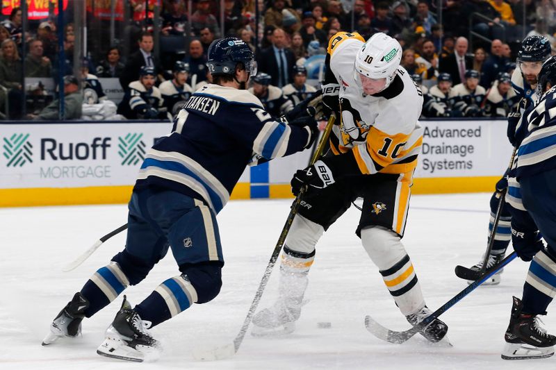 Nov 15, 2024; Columbus, Ohio, USA; Columbus Blue Jackets defenseman Jake Christiansen (2) checks Pittsburgh Penguins left wing Drew O'Connor (10) off the puck during the third period at Nationwide Arena. Mandatory Credit: Russell LaBounty-Imagn Images