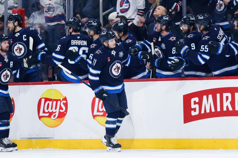 Jan 6, 2026; Winnipeg, Manitoba, CAN;  Winnipeg Jets forward Cole Perfetti (91) is congratulated by his team mates on his goal against the Vegas Golden Knights during the first period at Canada Life Centre. Mandatory Credit: Terrence Lee-Imagn Images