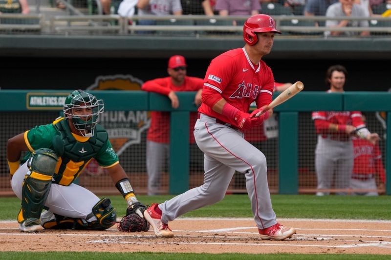 Mar 23, 2024; Mesa, Arizona, USA; Los Angeles Angels catcher Matt Thaiss (21) hits a single against the Oakland Athletics in the first inning at Hohokam Stadium. Mandatory Credit: Rick Scuteri-USA TODAY Sports