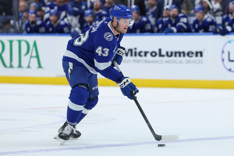 Dec 22, 2025; Tampa, Florida, USA; Tampa Bay Lightning defenseman Darren Raddysh (43) controls the puck against the St. Louis Blues in the first period at Benchmark International Arena. Mandatory Credit: Nathan Ray Seebeck-Imagn Images