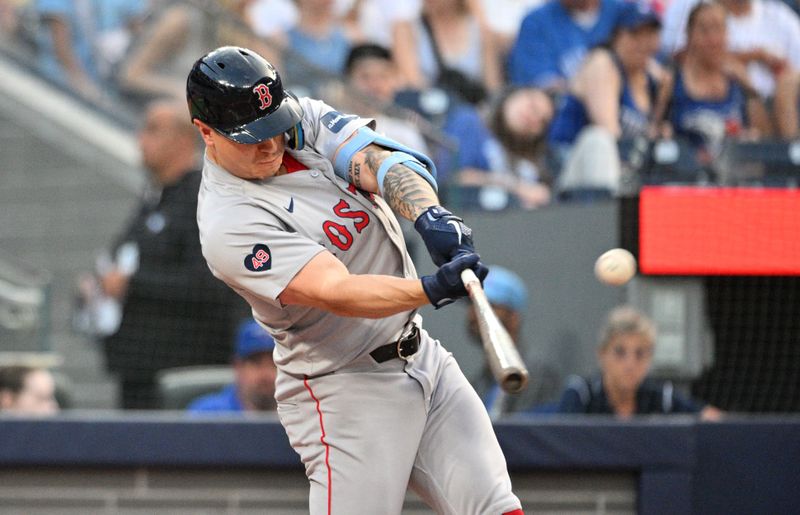 Jun 17, 2024; Toronto, Ontario, CAN;  Boston Red Sox designated hitter Tyler O'Neill (17) hits a solo home run against the Toronto Blue Jays in the third inning at Rogers Centre. Mandatory Credit: Dan Hamilton-USA TODAY Sports