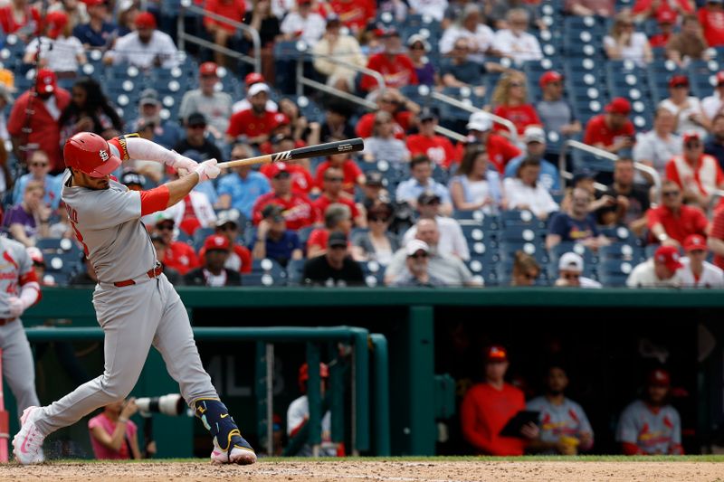 May 11, 2025; Washington, District of Columbia, USA; St. Louis Cardinals third base Nolan Arenado (28) hits a two run home run against the Washington Nationals during the eighth inning at Nationals Park. Mandatory Credit: Geoff Burke-Imagn Images