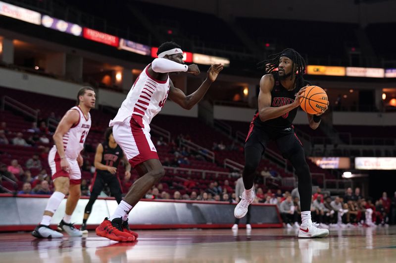 Feb 14, 2024; Fresno, California, USA; UNLV Rebels forward Keylan Boone (20) holds onto the ball next to Fresno State Bulldogs forward Pierre Geneste Jr. (34) in the first half at the Save Mart Center. Mandatory Credit: Cary Edmondson-USA TODAY Sports