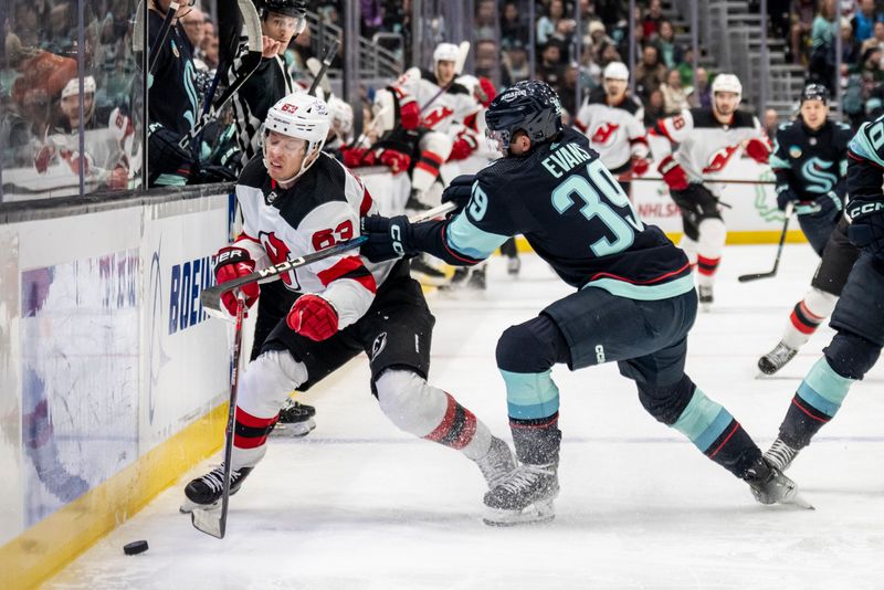 Dec 7, 2023; Seattle, Washington, USA; Seattle Kraken defensman Ryker Evans (39) checks New Jersey Devils forward Jesper Bratt (63) during the first period at Climate Pledge Arena. Mandatory Credit: Stephen Brashear-USA TODAY Sports