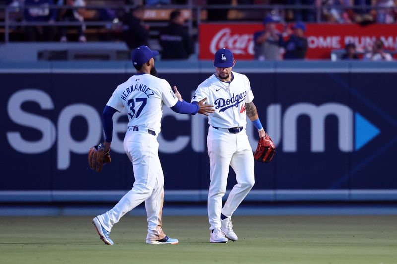 Jun 1, 2024; Los Angeles, California, USA;  Los Angeles Dodgers left fielder Teoscar Hernandez (37) and center fielder Andy Pages (44) celebrate a victory after defeating the Colorado Rockies 4-1 at Dodger Stadium. Mandatory Credit: Kiyoshi Mio-USA TODAY Sports