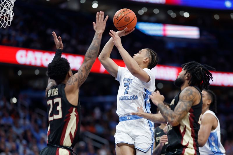 Mar 14, 2024; Washington, D.C., USA; North Carolina guard Seth Trimble (7) shoots the ball as Florida State guard Primo Spears (23) defends in the second half at Capital One Arena. Mandatory Credit: Geoff Burke-USA TODAY Sports