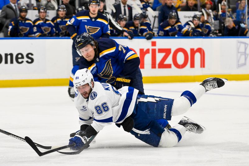 Nov 5, 2024; St. Louis, Missouri, USA;  Tampa Bay Lightning right wing Nikita Kucherov (86) and St. Louis Blues center Oskar Sundqvist (70) battle for the puck during the first period at Enterprise Center. Mandatory Credit: Jeff Curry-Imagn Images