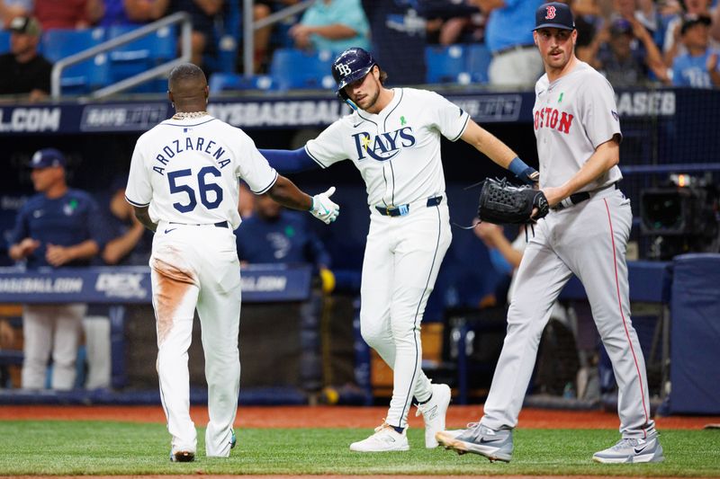 May 21, 2024; St. Petersburg, Florida, USA;  Tampa Bay Rays outfielder Randy Arozarena (56) and designated hitter Josh Lowe (15) celebrate after scoring runs against the Baltimore Ravens in the first quarter at Tropicana Field. Mandatory Credit: Nathan Ray Seebeck-USA TODAY Sports