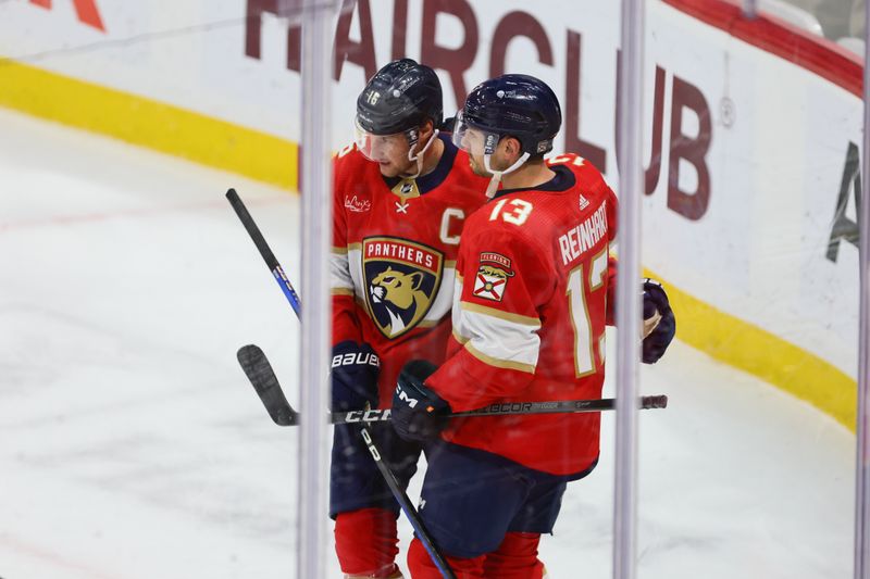 Apr 13, 2024; Sunrise, Florida, USA; Florida Panthers center Sam Reinhart (13) celebrates with center Aleksander Barkov (16) after scoring against the Buffalo Sabres in overtime at Amerant Bank Arena. Mandatory Credit: Sam Navarro-USA TODAY Sports