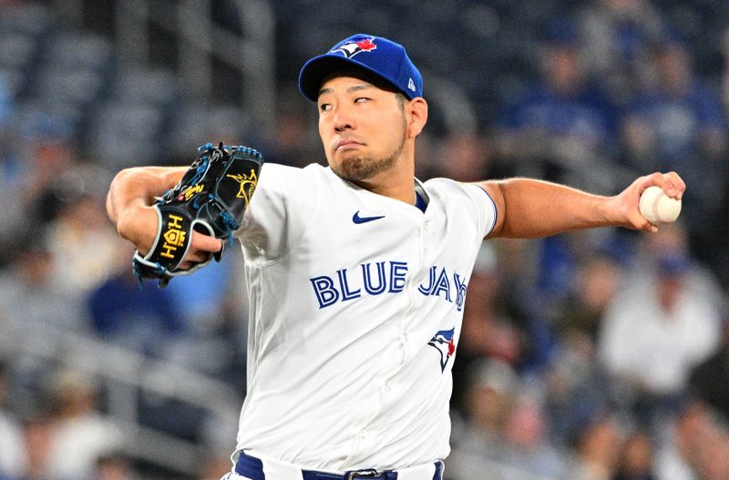 Apr 10, 2024; Toronto, Ontario, CAN;   Toronto Blue Jays starting pitcher Yusei Kikuchi (16) delivers a pitch against the Seattle Mariners in the first inning at Rogers Centre. Mandatory Credit: Dan Hamilton-USA TODAY Sports