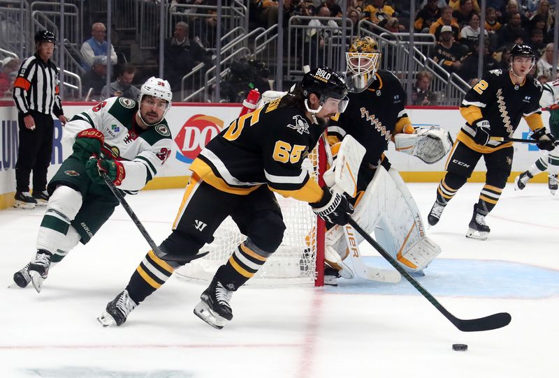 Oct 29, 2024; Pittsburgh, Pennsylvania, USA; Pittsburgh Penguins defenseman Erik Karlsson (65) skates with the puck as Minnesota Wild right wing Mats Zuccarello (36) chases during the second period at PPG Paints Arena. Mandatory Credit: Charles LeClaire-Imagn Images